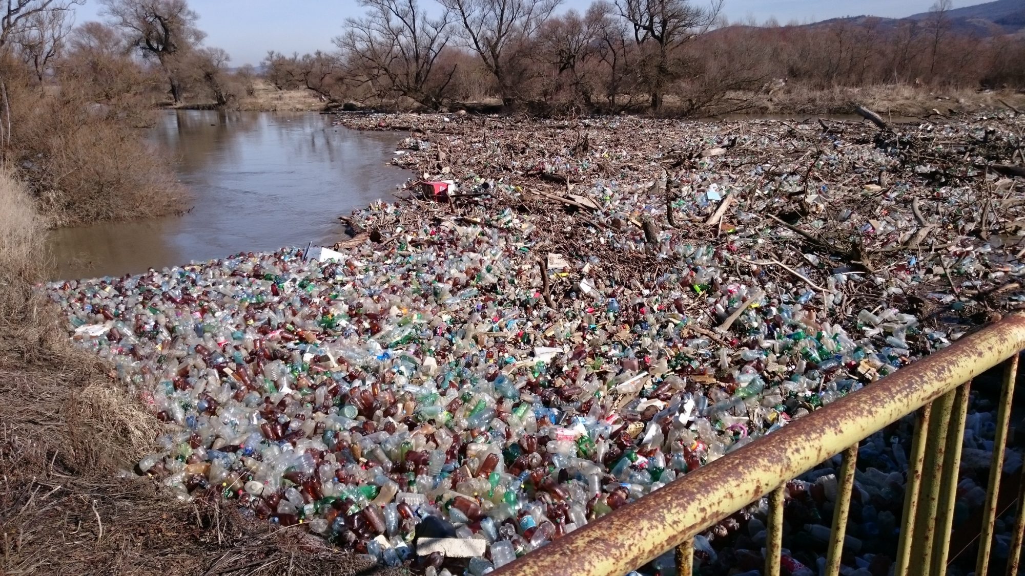 Polution with plastic waste on a river