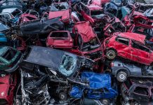 Old rusty cars piled up on top of each other in scrapyard