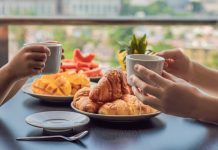 Breakfast table set with croissants and fruit