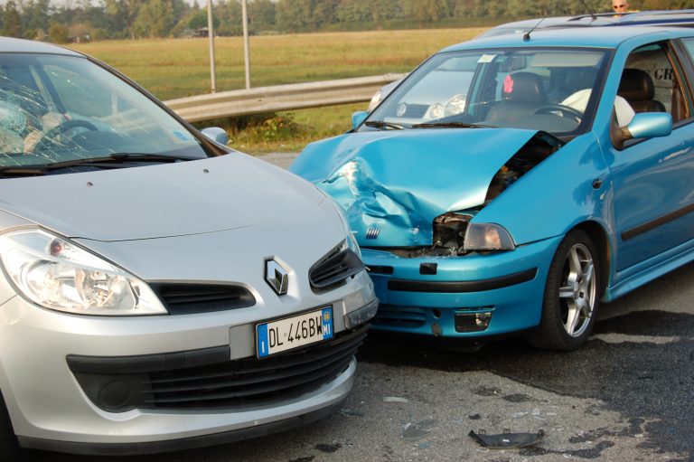 Silver and blue car crashed into each other