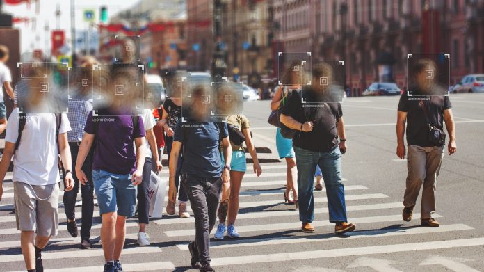 Group of people walking down street with faces blurred