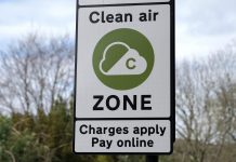 Road sign reading 'CLEAN AIR ZONE CHARGES APPLY PAY ONLINE'