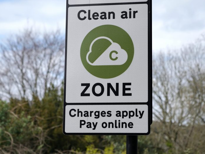 Road sign reading 'CLEAN AIR ZONE CHARGES APPLY PAY ONLINE'