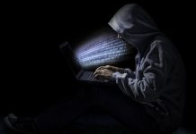 Man in dark room suggestive of cyber attack