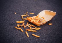 Box of chips spilling over concrete floor