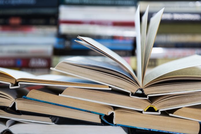 science education reform, A stack of books with colorful covers