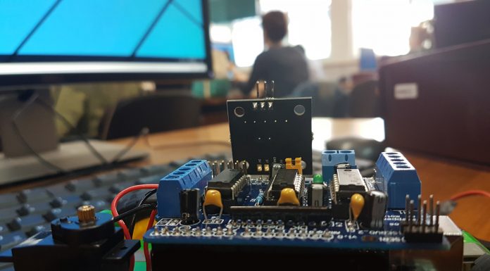 student in a STEM classroom learning robotics