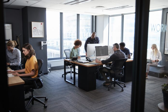 creative team working together at computers in a casual office