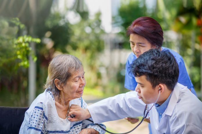 Helping an elderly patient in Japan