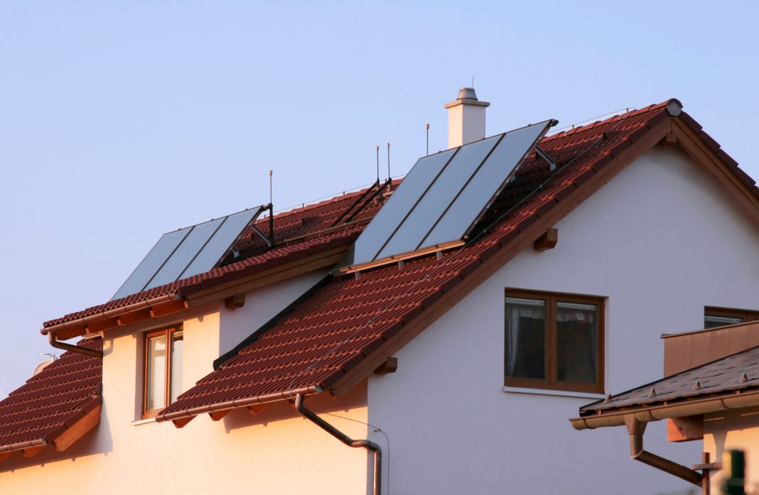 Family house with solar panels on the roof for water heating