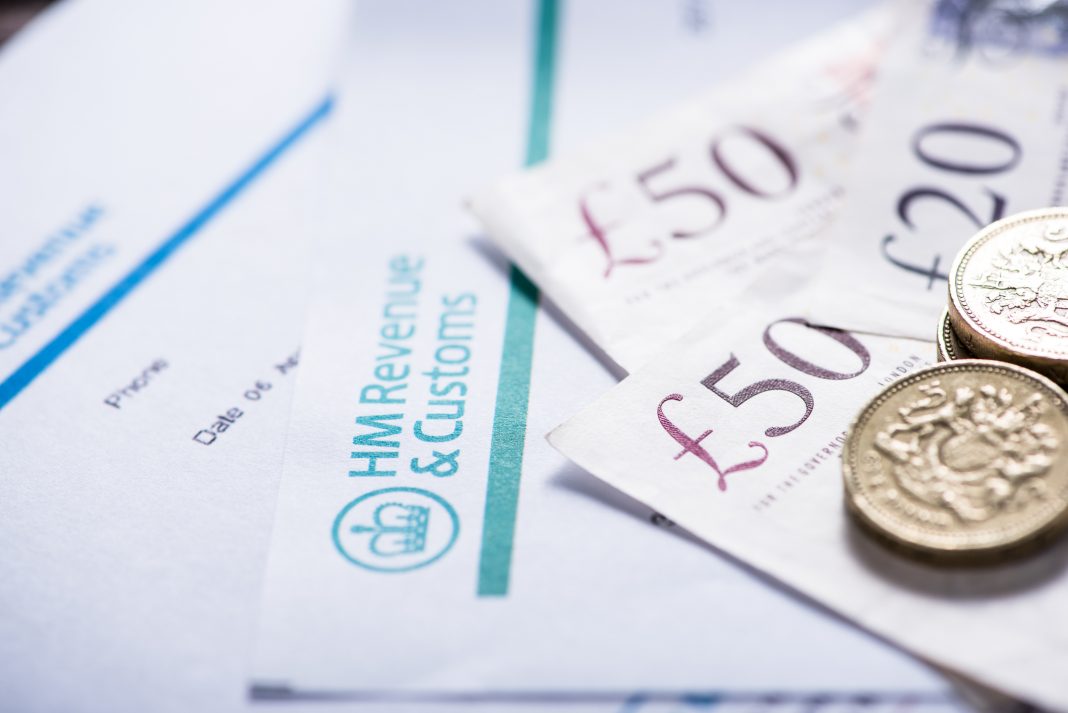 uk banknotes and money on a tax paper