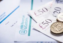 uk banknotes and money on a tax paper