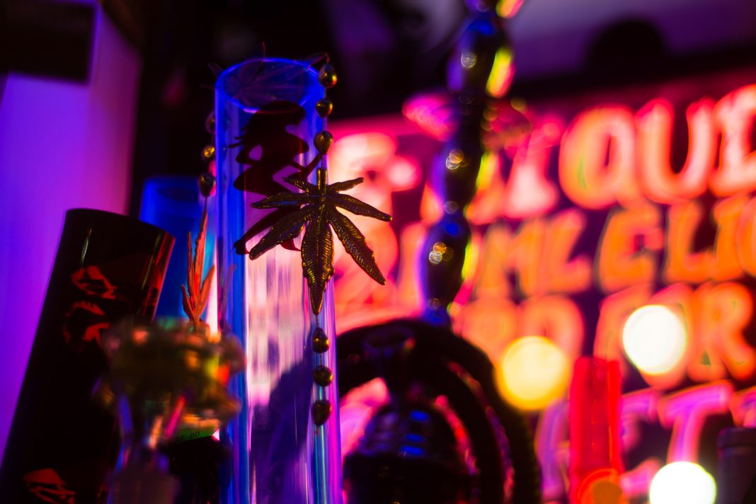 Bong and gold cannabis leaf in shop window