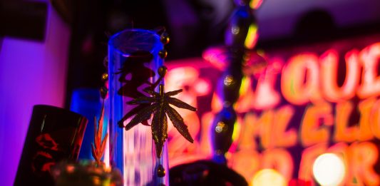 Bong and gold cannabis leaf in shop window