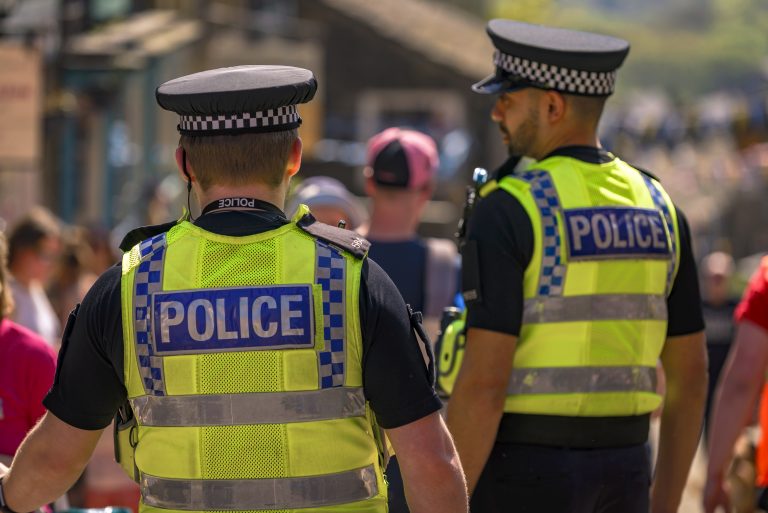 Why are UK police legitimacy and community relations so low?