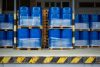Toxic waste/chemicals stored in barrels at a plant - blue cans with chemicals, industry oil barrels