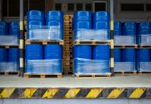 Toxic waste/chemicals stored in barrels at a plant - blue cans with chemicals, industry oil barrels