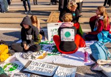 Children sat on floor with climate change posters
