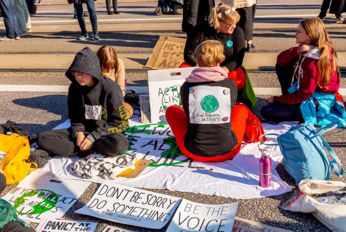 Children sat on floor with climate change posters