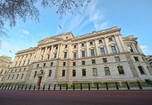 HM Treasury building in London looms against a blue sky