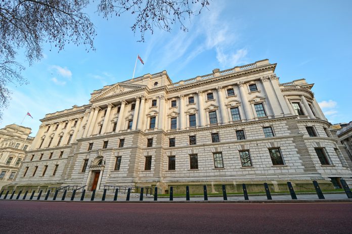 HM Treasury building in London looms against a blue sky