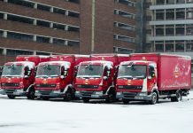 Royal Mail trucks lined up covered in snow