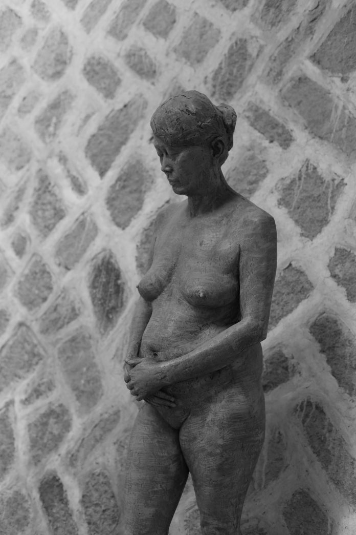 Stone statue of pregnant woman