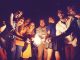 Group setting under dark sky using sparklers, happy faces, enjoying leisure time