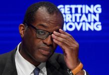 Kwasi Kwarteng holds is head in his hands