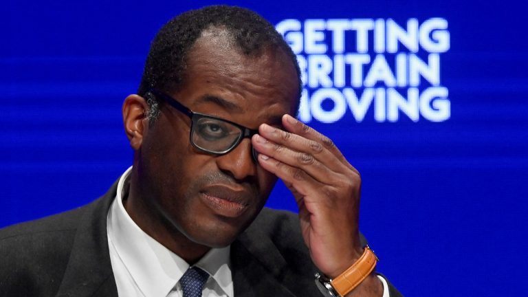 Kwasi Kwarteng holds is head in his hands