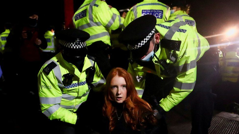 Image of a woman tackled by police at a vigil for Sarah Everard