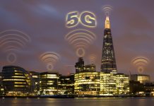 5G concept in the city. Many wireless symbols on the top of the buildings