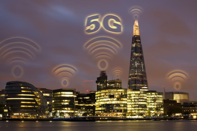 5G concept in the city. Many wireless symbols on the top of the buildings