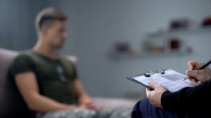 Psychologist making notes during therapy session