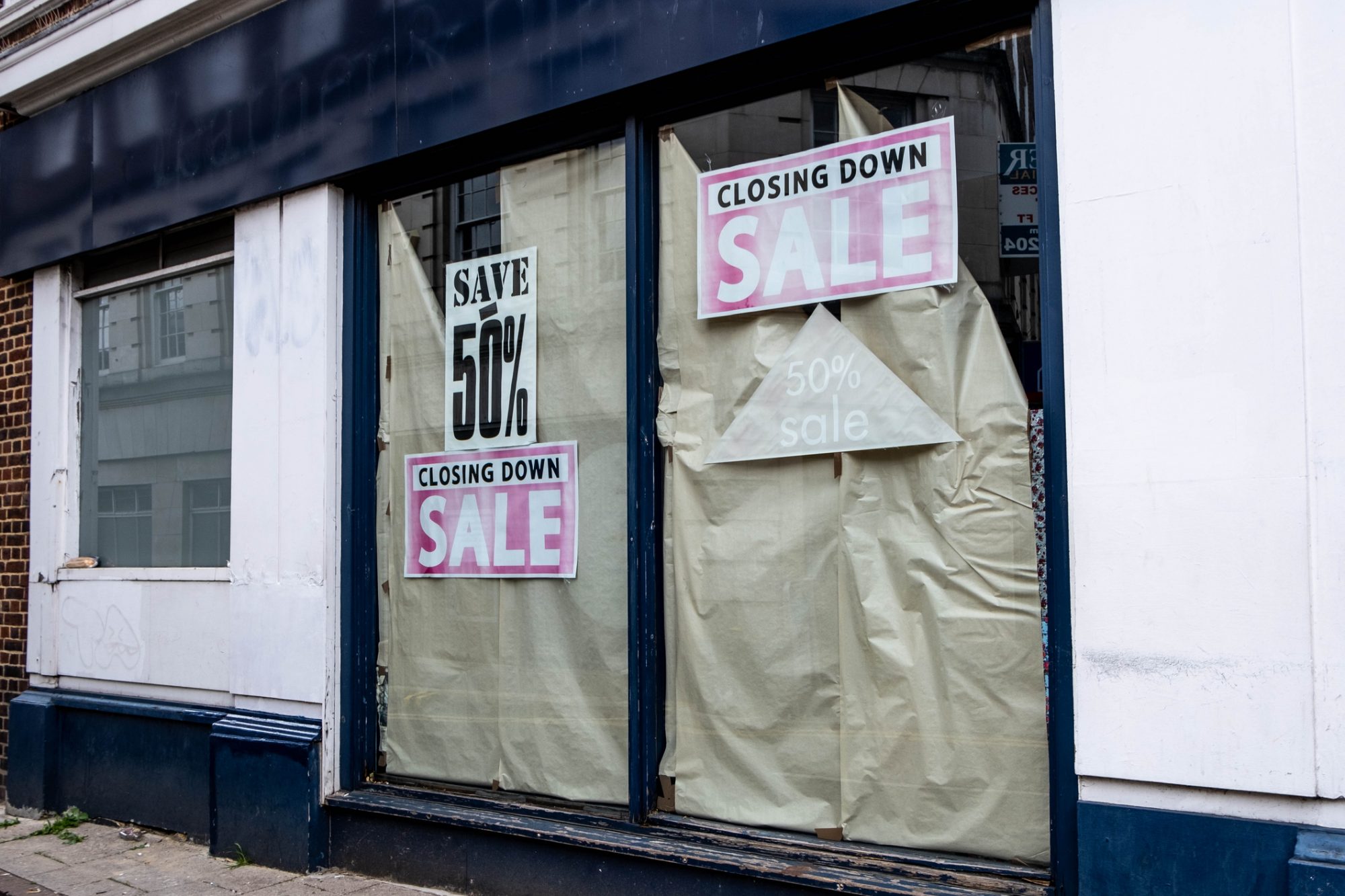 Closing Down Sale Sign In A Shop Window In A Failed Retail Business