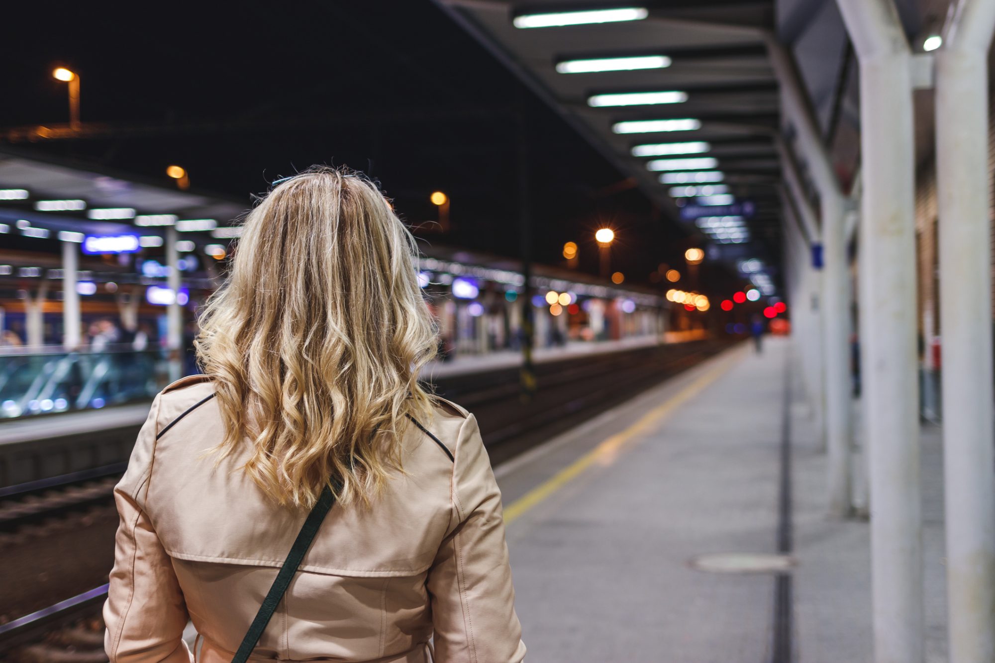 Woman waiting for train at railroad station