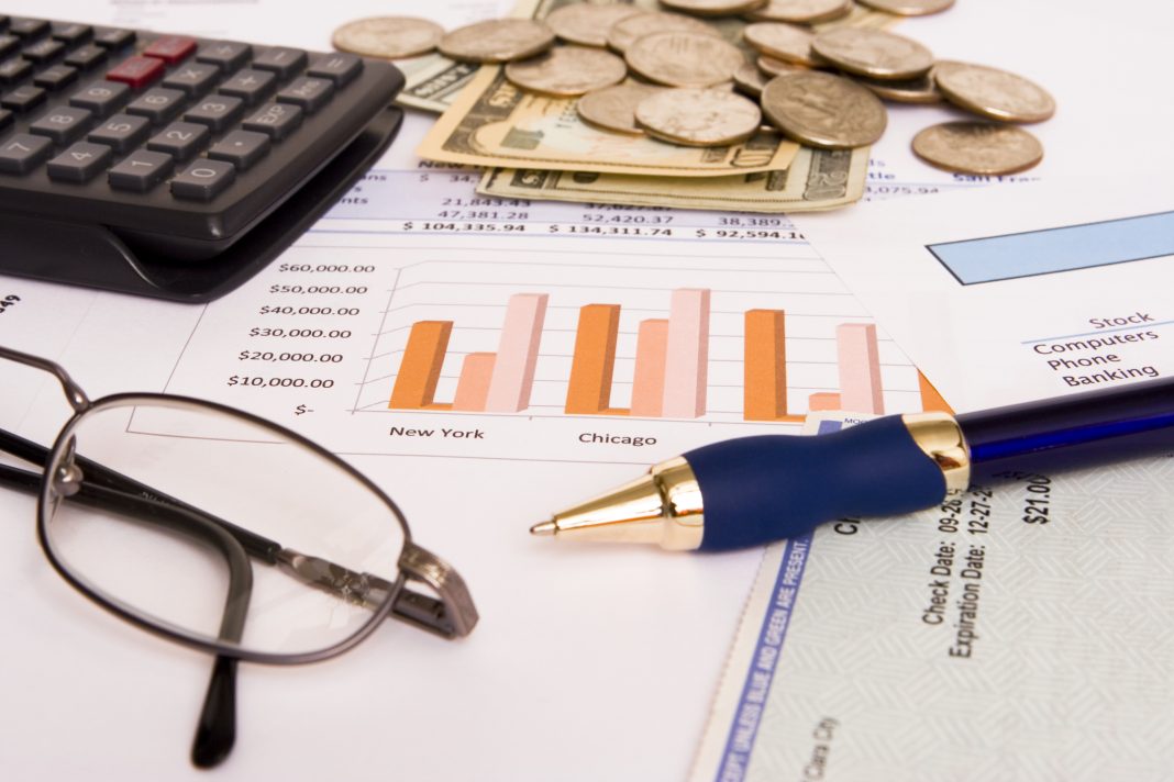 Small business finances objects with glasses and pen