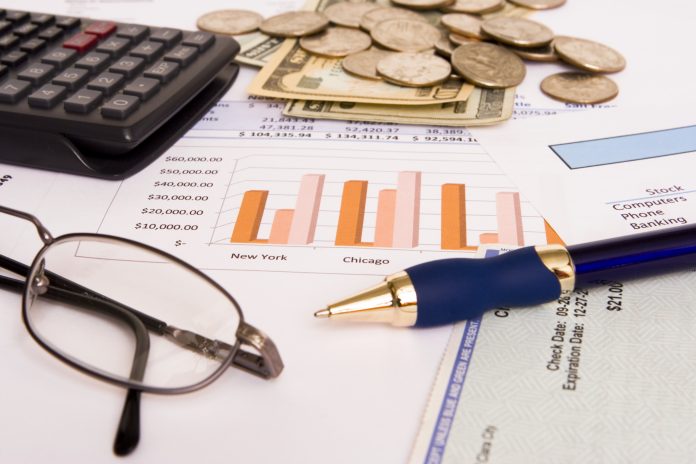 Small business finances objects with glasses and pen