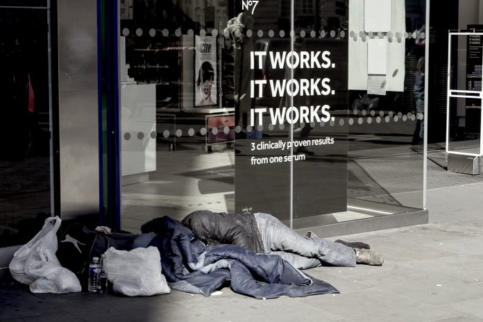 Homeless man begging on Oxford street, London