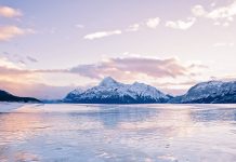 Methane Bubbles frozen in Abraham Lake in Clearwater County, near Nordegg, Alberta, Canada. Elliot Peak lit by the sunset in the background. Canadian Winter scene