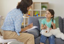 Woman sitting on chair discussing ADHD with child
