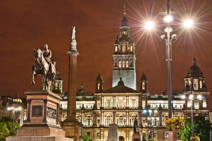 George Square in Glasgow at night, bright lights, buildings