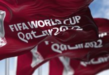 Three flags with the Qatar 2022 Fifa World Cup logo waving in the wind