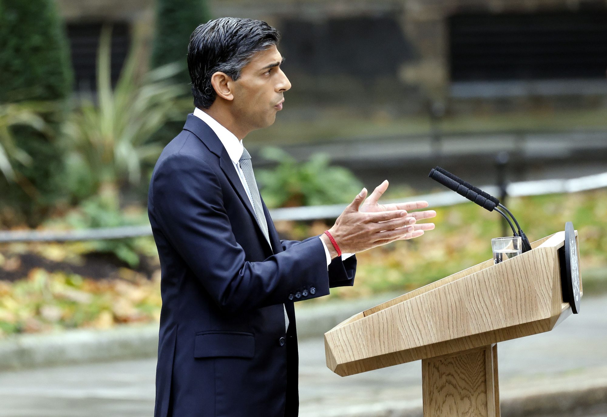 UK Prime Minister Rishi Sunak making speech at podium in London