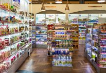 Inside of pharmacy shop, shelves full of medicine and supplements