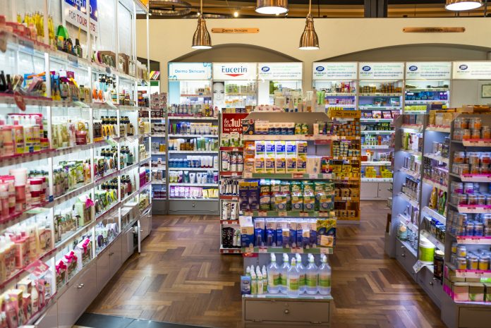Inside of pharmacy shop, shelves full of medicine and supplements