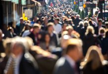 Crowd of people walking on city street to work