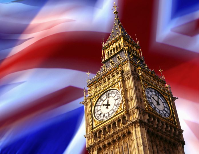 The Clock Tower of Big Ben in London in Great Britain pictured in front of the Union Jack flag