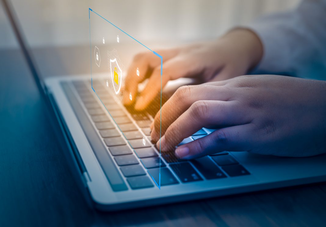 Businessman using a laptop computer with technology cybersecurity and privacy concept. protection and safe data for global network security