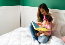 mom reading a children`s book to baby